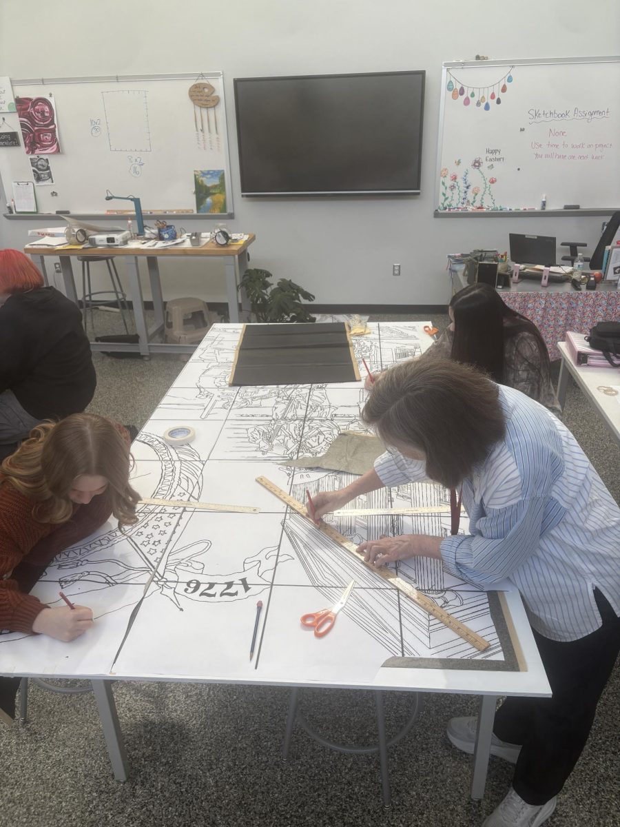 Students work on sketching out the mural. 