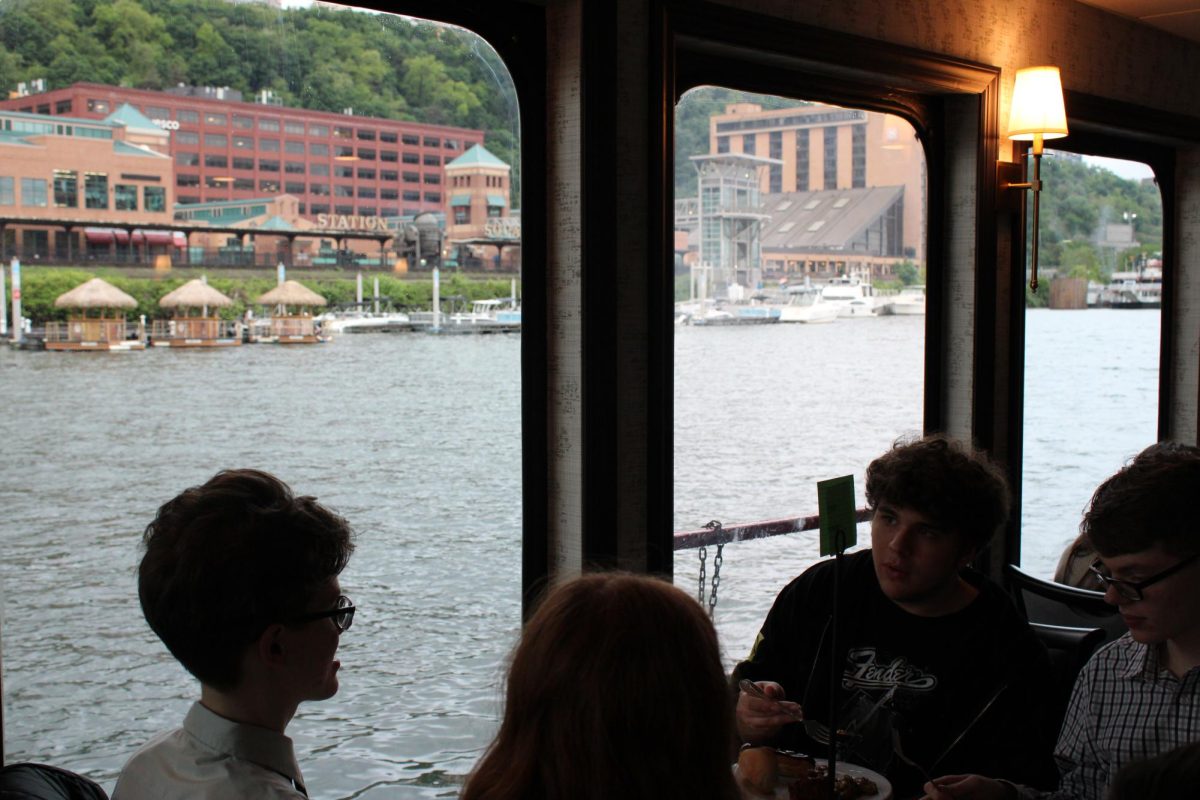 Dining, chatting, and a nice view. Even from inside the boat, the open windows give a clear view of Pittsburgh.