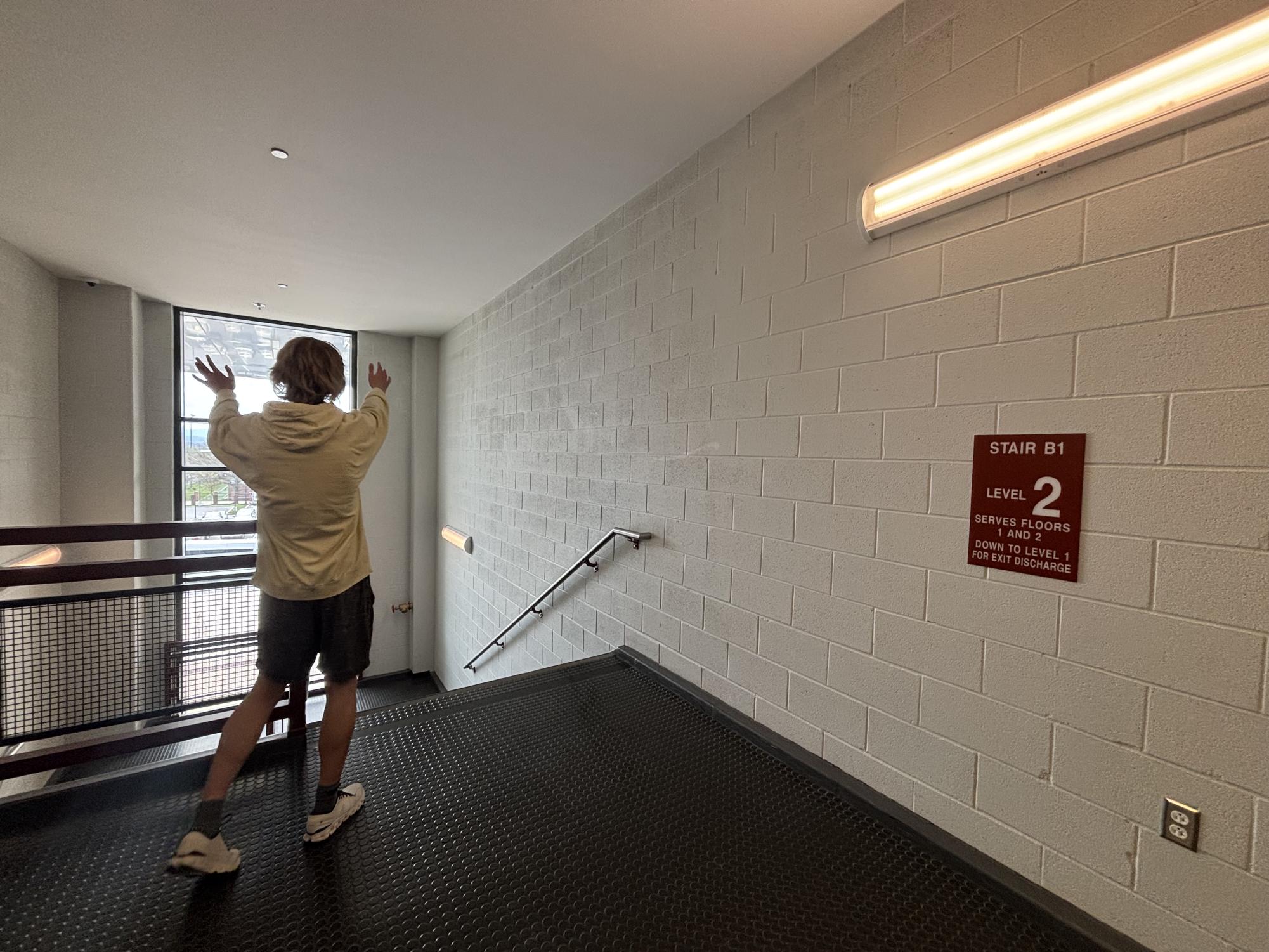 Senior Braxton Eckenrode admired stairwell B1. The stairwell features a view out toward the packing lot and direct access to music classrooms. 